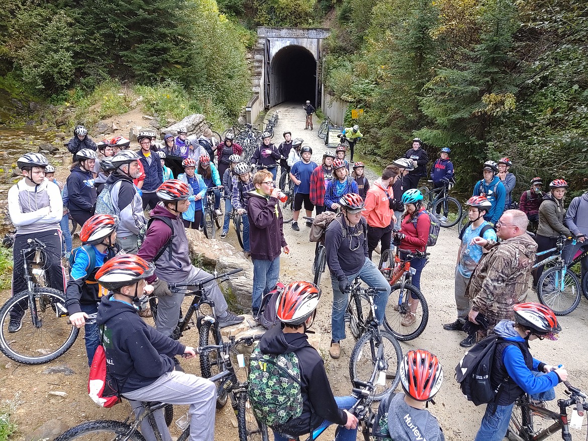 Paul Elston (standing on the right) gives the students a quick history lesson during one of their stops on their bike ride.