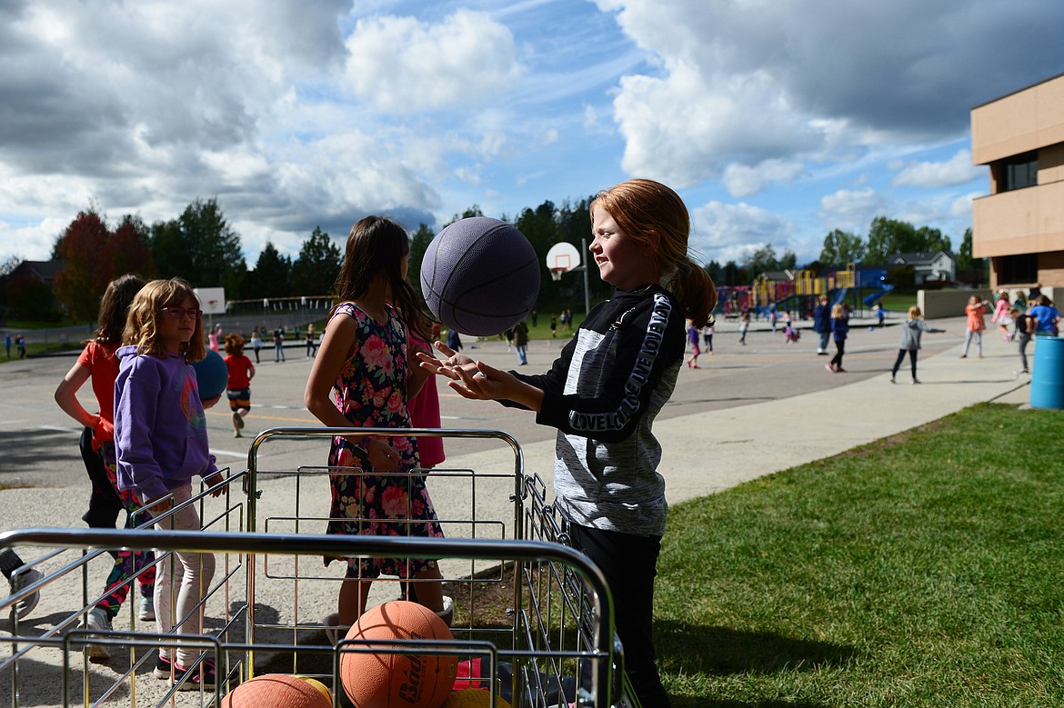 Third-grade students select playground balls from a bin during recess at Edgerton Elementary School in Kalispell on Tuesday, Sept. 24. (Casey Kreider/Daily Inter Lake)