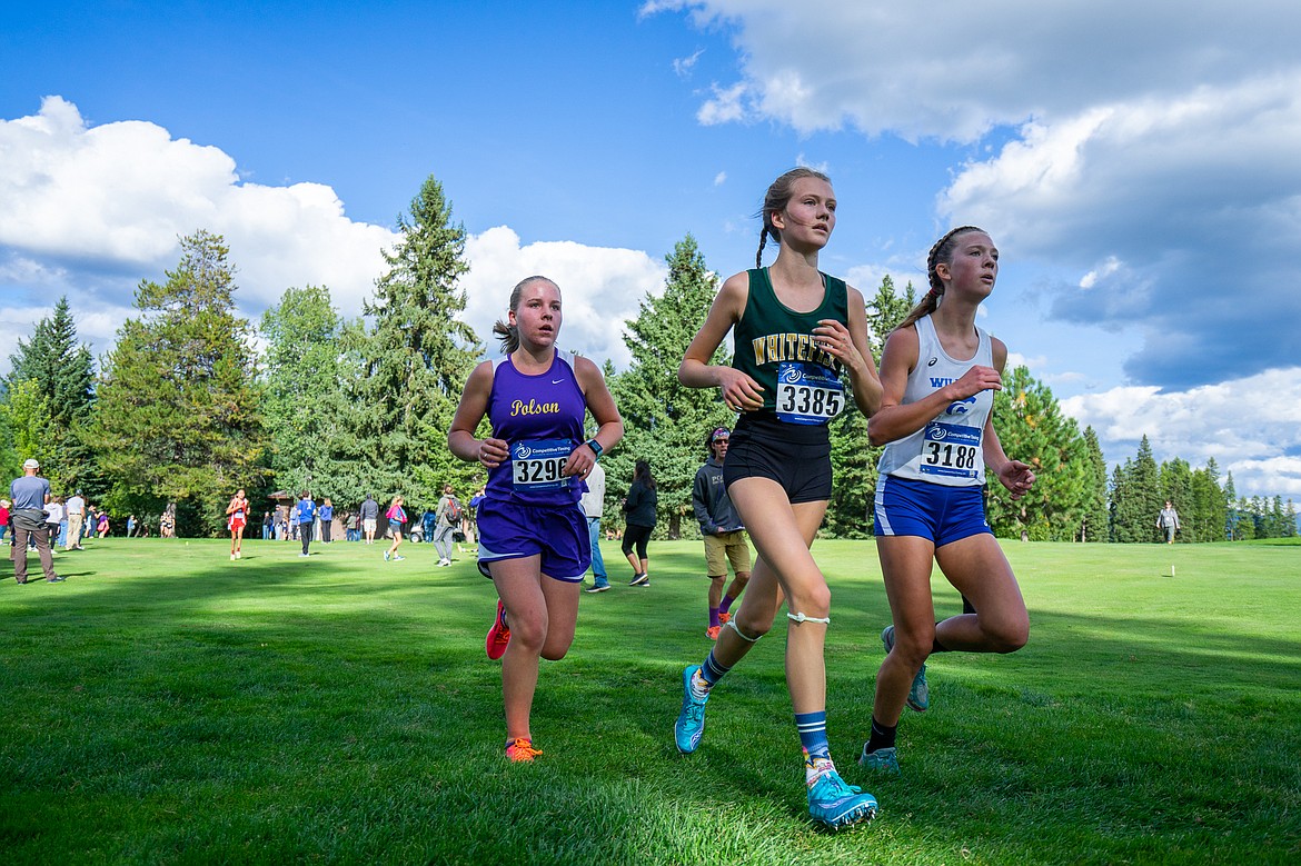 Paetra Cooke keeps pace with Wildcat and Pirate runners during the Whitefish Invite last Tuesday at Whitefish Lake Golf Club. (Daniel McKay/Whitefish Pilot)