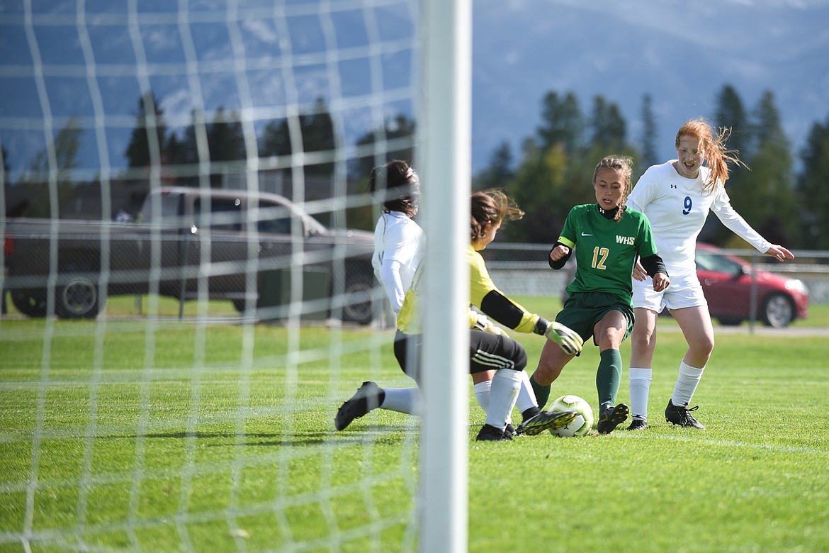 Anna Cook attacks a well-defended goal and eventually scores during Saturday&#146;s homecoming win over Libby. (Daniel McKay/Whitefish Pilot)