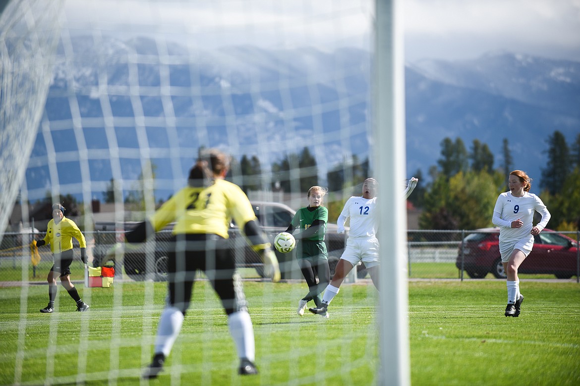 Sophie Olson attacks the net during Saturday&#146;s homecoming win over Libby. (Daniel McKay/Whitefish Pilot)