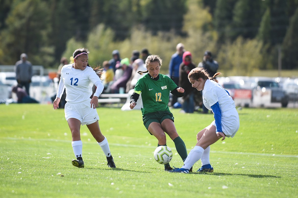 Anna Cook finds space between defenders during Saturday&#146;s homecoming win over Libby. (Daniel McKay/Whitefish Pilot)