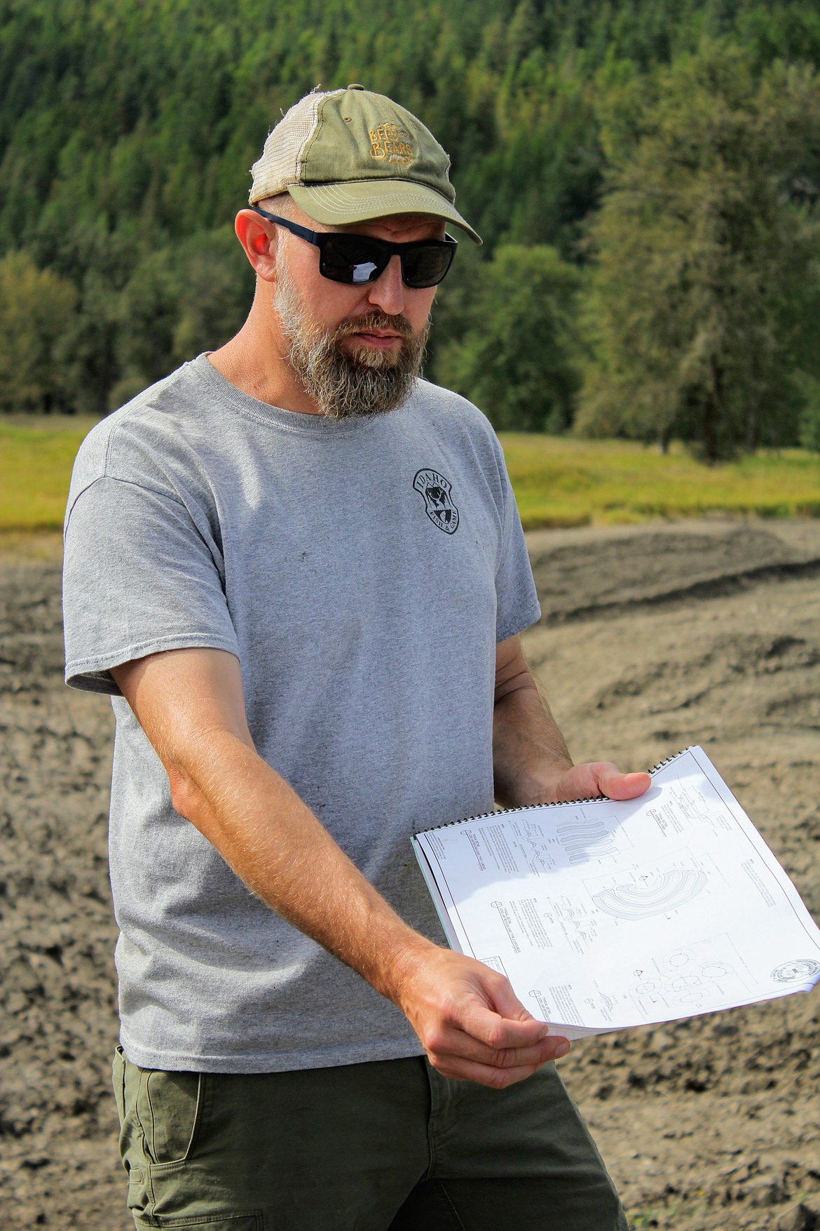 Photo by TONIA BROOKS
Michael Lucid Panhandle Regional Wildlife Diversity Biologist, displays the pond schematics.