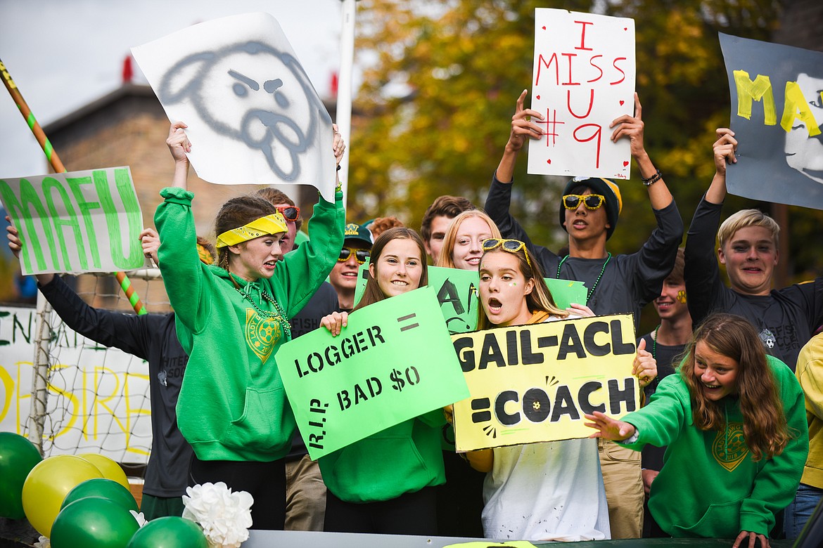 The Bulldogs soccer teams cheer from atop their float during the Homecoming parade on Friday. (Daniel McKay/Whitefish Pilot)