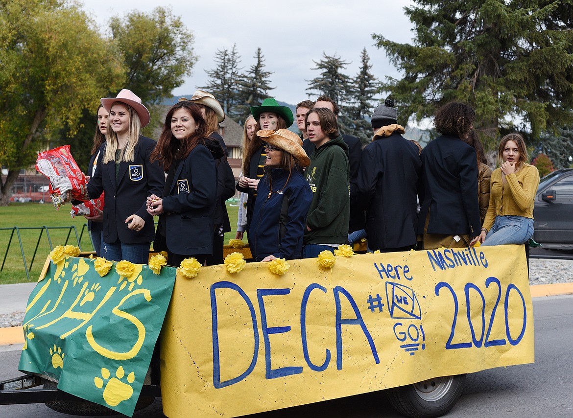 The DECA club rides in Whitefish High School homecoming parade Friday afternoon through downtown. (Heidi Desch/Whitefish Pilot)