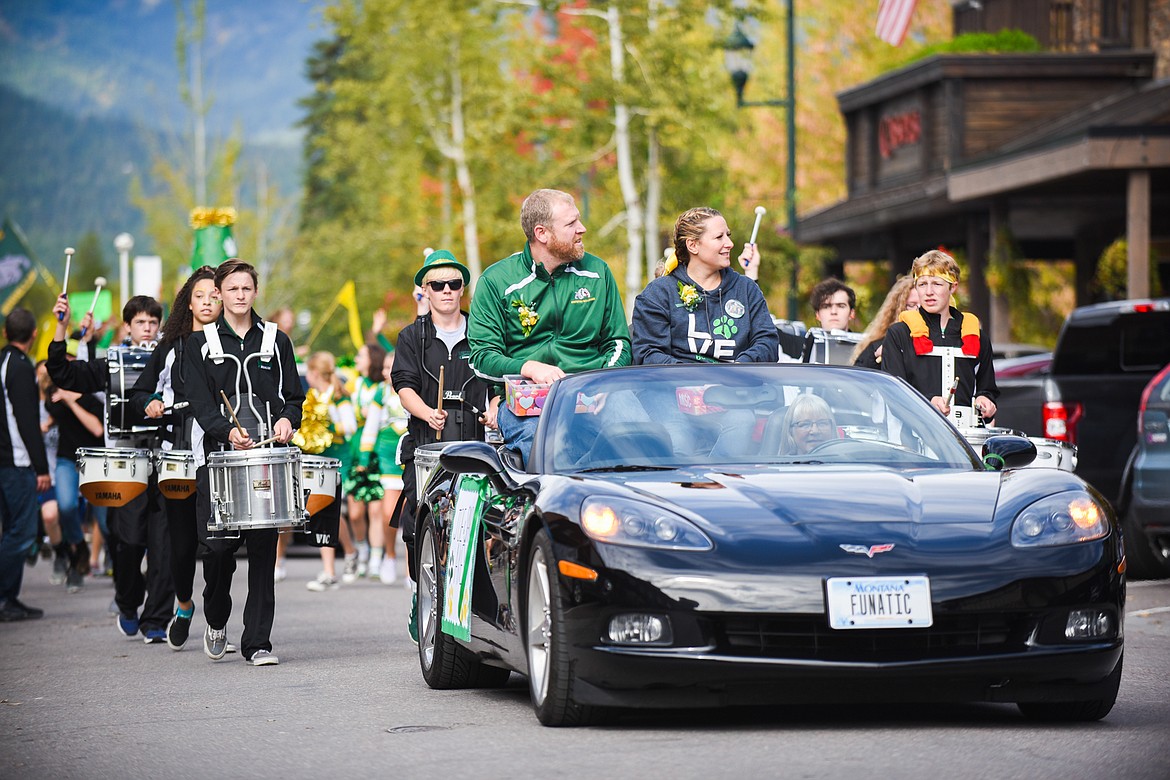 Joe and Sarah Akey lead the Bulldog marching band during the Homecoming parade on Friday. (Daniel McKay/Whitefish Pilot)