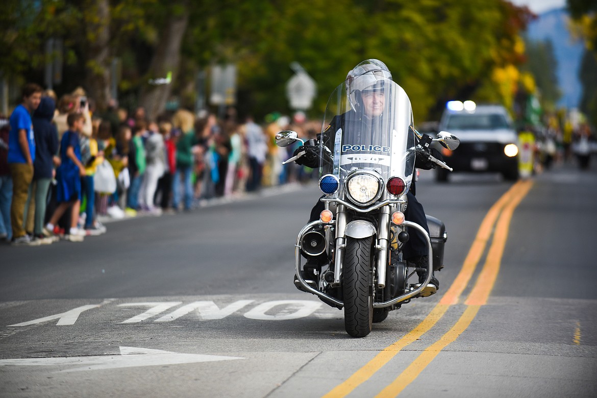 Whitefish Police Officer Rob Veneman leads the way during the Homecoming parade on Friday. (Daniel McKay/Whitefish Pilot)