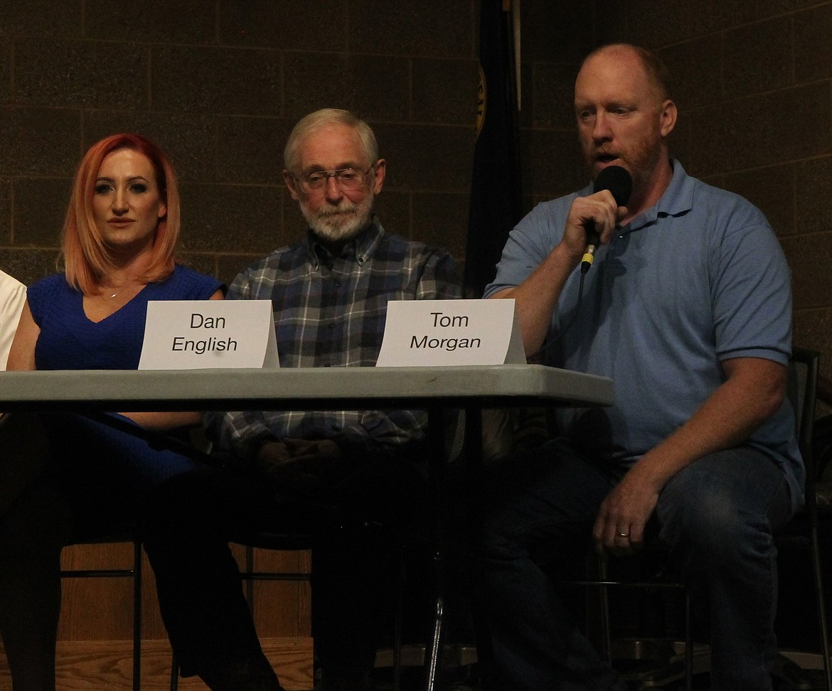 Coeur d'Alene Council Seat 5 challenger Tom Morgan (right), sitting next to incumbant Dan English and fellow challenger Lacey Moen, stretched his political legs Thursday night with a pair of jabs toward English's stances on urban renewal districts. (CRAIG NORTHRUP/Press)