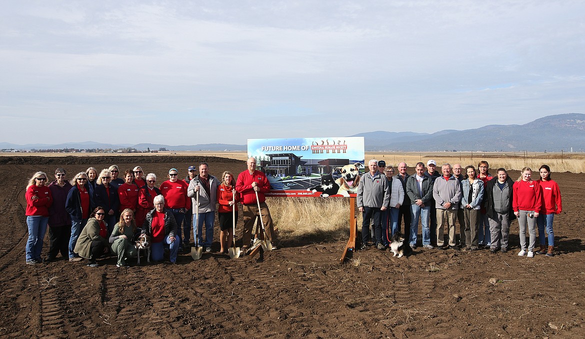 LOREN BENOIT/Press
Kootenai Humane Society board members, staff, volunteers, and supporters gathered on the 10-acre parcel on Atlas Road Wednesday to celebrate breaking ground for the new Kootenai Humane Society building. Left side, front row, from left: Claudett Kasper, Angie Hanson with Paris, Debbie Jeffery. Second row, from left: Jan Davidson, Cathy Moehling, Kelly Gill, Joyce Crettol, Cynthia McNeil, Andy Smith, Kootenai Humane Society Executive Director Cindy Edington, and Rick Rasmussen, chairman of the capital campaign. Back row: Michelle Gilbertson, Cathy Parker, Tammy Lambert, Jane Donovan, Gloria Neuharth, and David Espen. Right side, front row from left: Corey Trapp, Kathy Boggs with Lola, Craig Aurora, Jim Foucher, Tina Edwards-Raver, Jennifer Abraham, Chelsea Cosgrove, and Tessa Moreno.