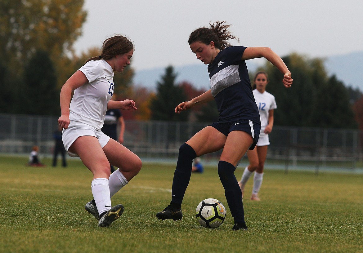 Lake City&#146;s Izzy Henkle dribbles the ball around Coeur d&#146;Alene&#146;s Maia Keith in the first half of Wednesday&#146;s 5A Region 1 Championship game at Lake City. (LOREN BENOIT/Press)