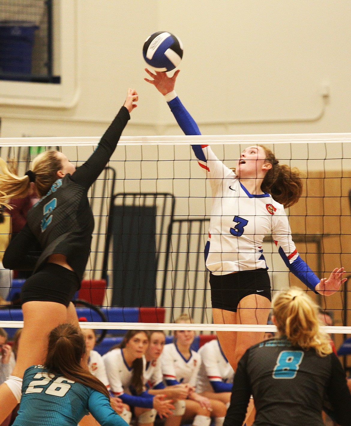 LOREN BENOIT/Press 
Coeur dAlene Highs Lauren Phillips tips the ball over the net with Lake Citys Janae Rayborn defending during Tuesdays match at Viking Court.
