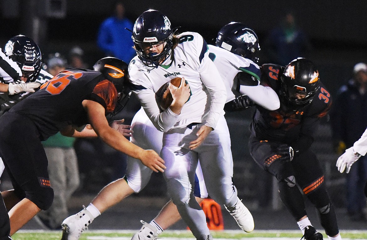 Glacier quarterback Braedy Santens (9) looks for running room against Flathead during a crosstown matchup at Legends Stadium on Friday. (Casey Kreider/Daily Inter Lake)