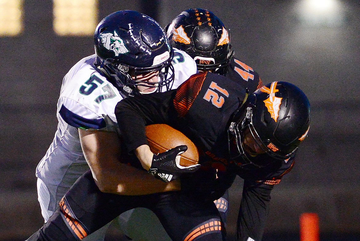 Glacier's Henry Nuce (57) sacks Flathead quarterback Cooper Smith (12) in the first quarter during a crosstown matchup at Legends Stadium on Friday. (Casey Kreider/Daily Inter Lake)