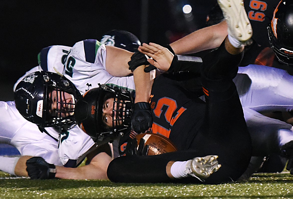 Glacier defensive lineman Henry Nuce (57) sacks Flathead quarterback Cooper Smith (12) in the first quarter during a crosstown matchup at Legends Stadium on Friday. (Casey Kreider/Daily Inter Lake)