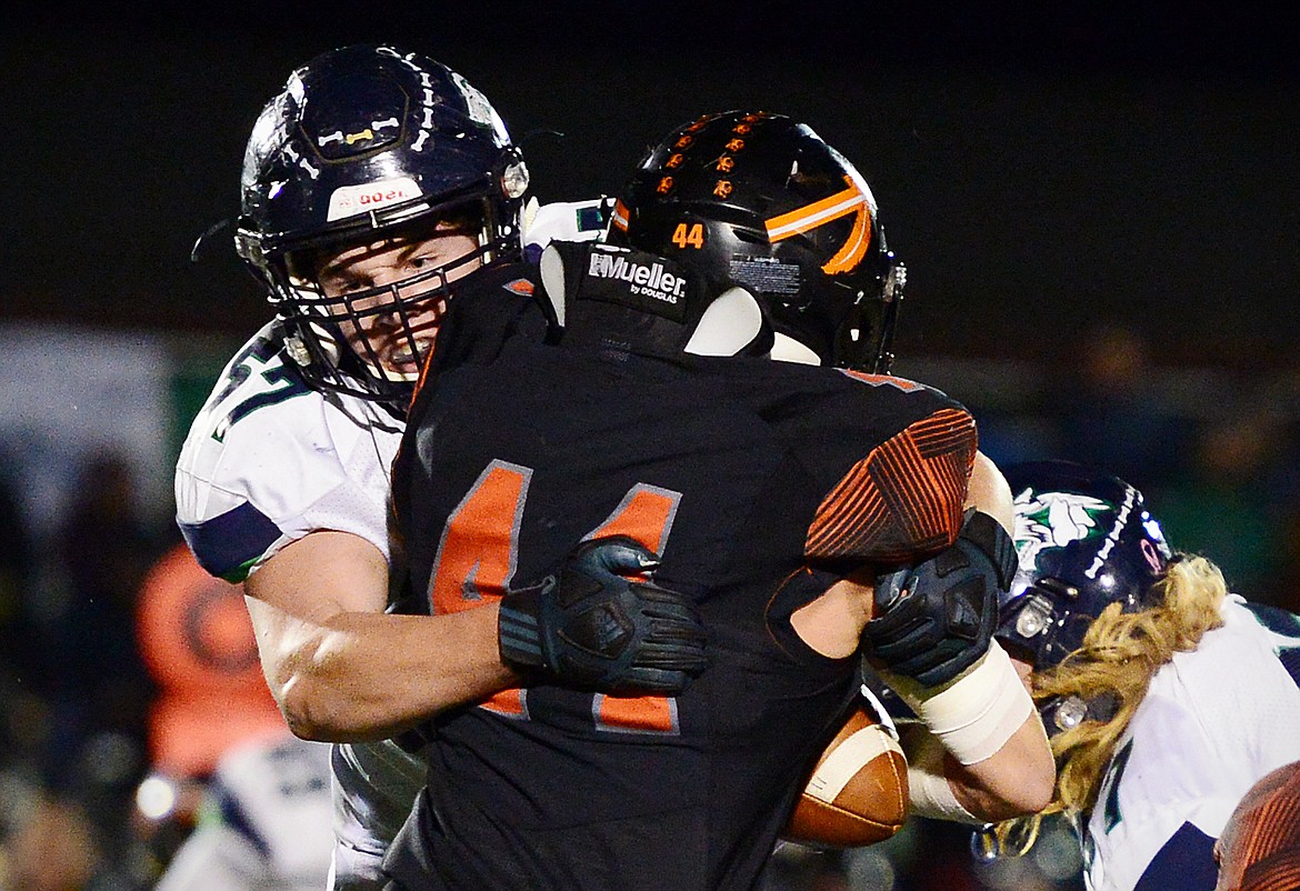 Glacier defensive lineman Henry Nuce (57) stops Flathead running back Tanner Russell (44) in the first quarter during a crosstown matchup at Legends Stadium on Friday. (Casey Kreider/Daily Inter Lake)