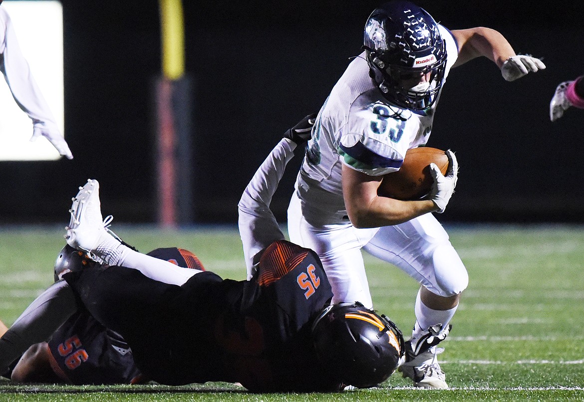 Glacier running back Jake Rendina (33) is brought down by Flathead linebacker Nolan White (35) during a crosstown matchup at Legends Stadium on Friday. (Casey Kreider/Daily Inter Lake)