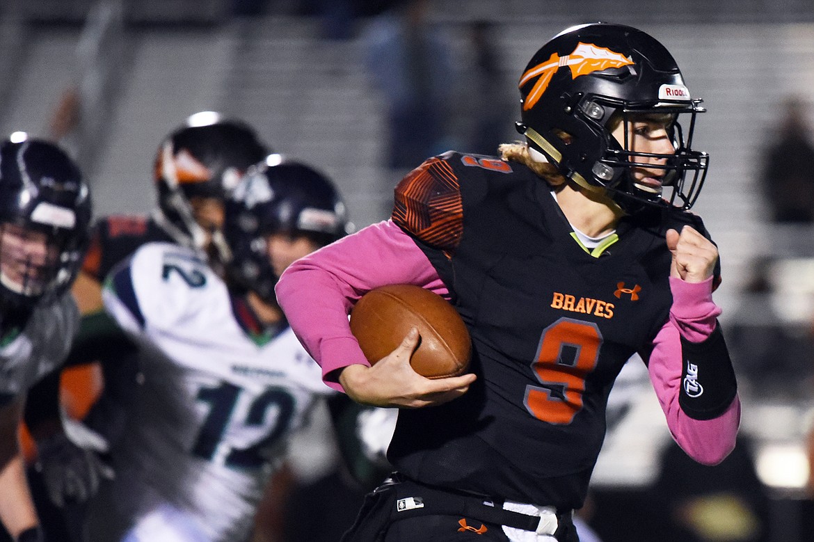 Flathead quarterback Charlie Hinchey (9) looks for room to run against Glacier during a crosstown matchup at Legends Stadium on Friday. (Casey Kreider/Daily Inter Lake)