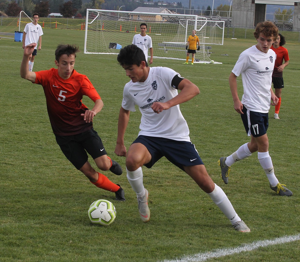 JASON ELLIOTT/Press
Lake City midfielder Jackson Henkle moves the ball up the field on Post Falls&#146; Caleb Calkins during the second half of Saturday&#146;s 5A Region 1 boys soccer match at Post Falls High.