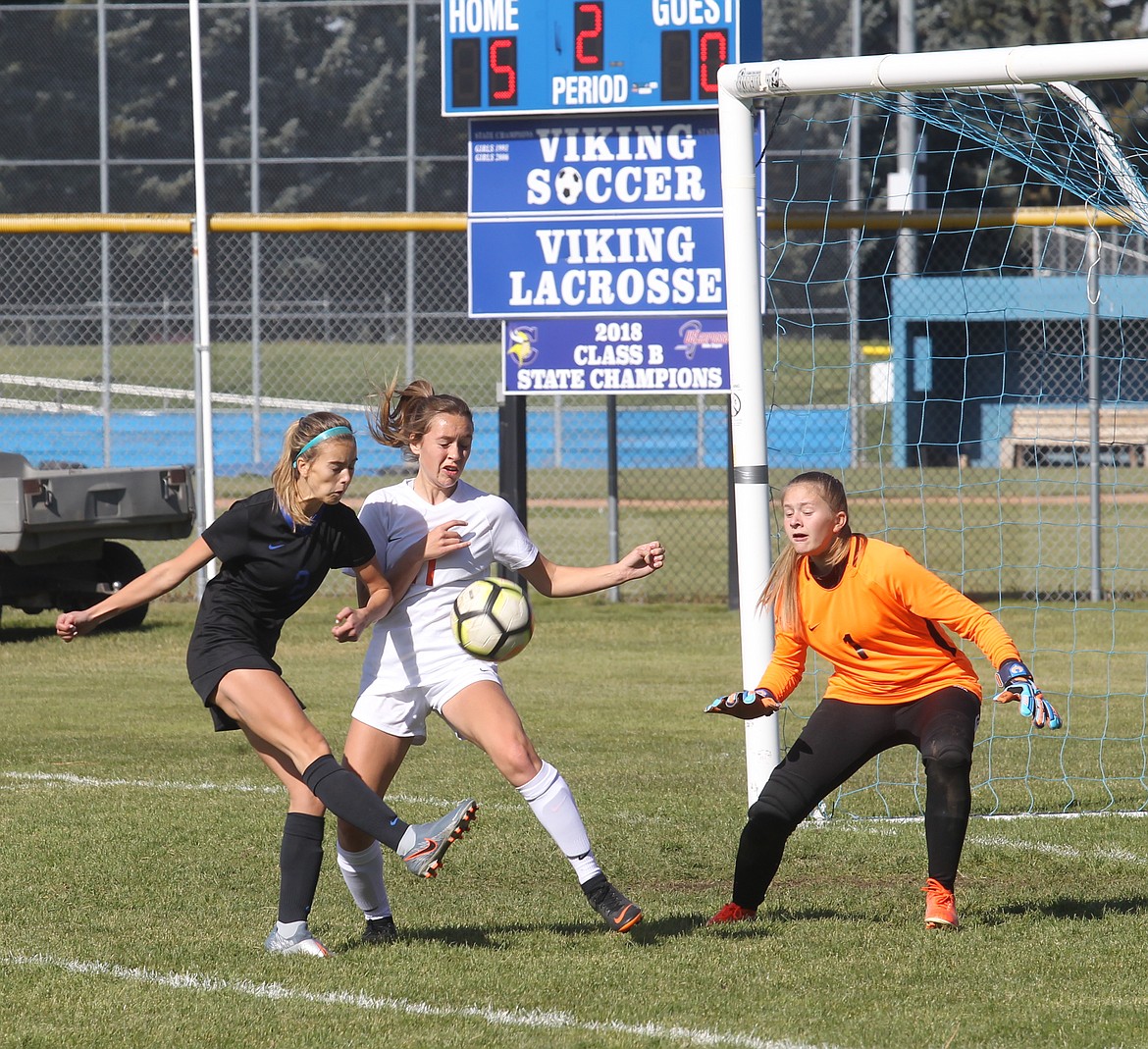 MARK NELKE/Press
Erin McPhee, left, of Coeur d&#146;Alene takes a shot on goal as Trinidie Nichols (11) of Post Falls and goalkeeper Ashley Grant defend.