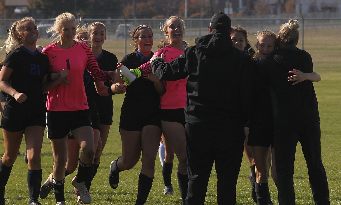 MARK NELKE/Press
Coeur d&#146;Alene players race toward their coaches Saturday at Coeur d&#146;Alene High after qualifying for the state 5A girls soccer tournament with a 5-0 victory over Post Falls.