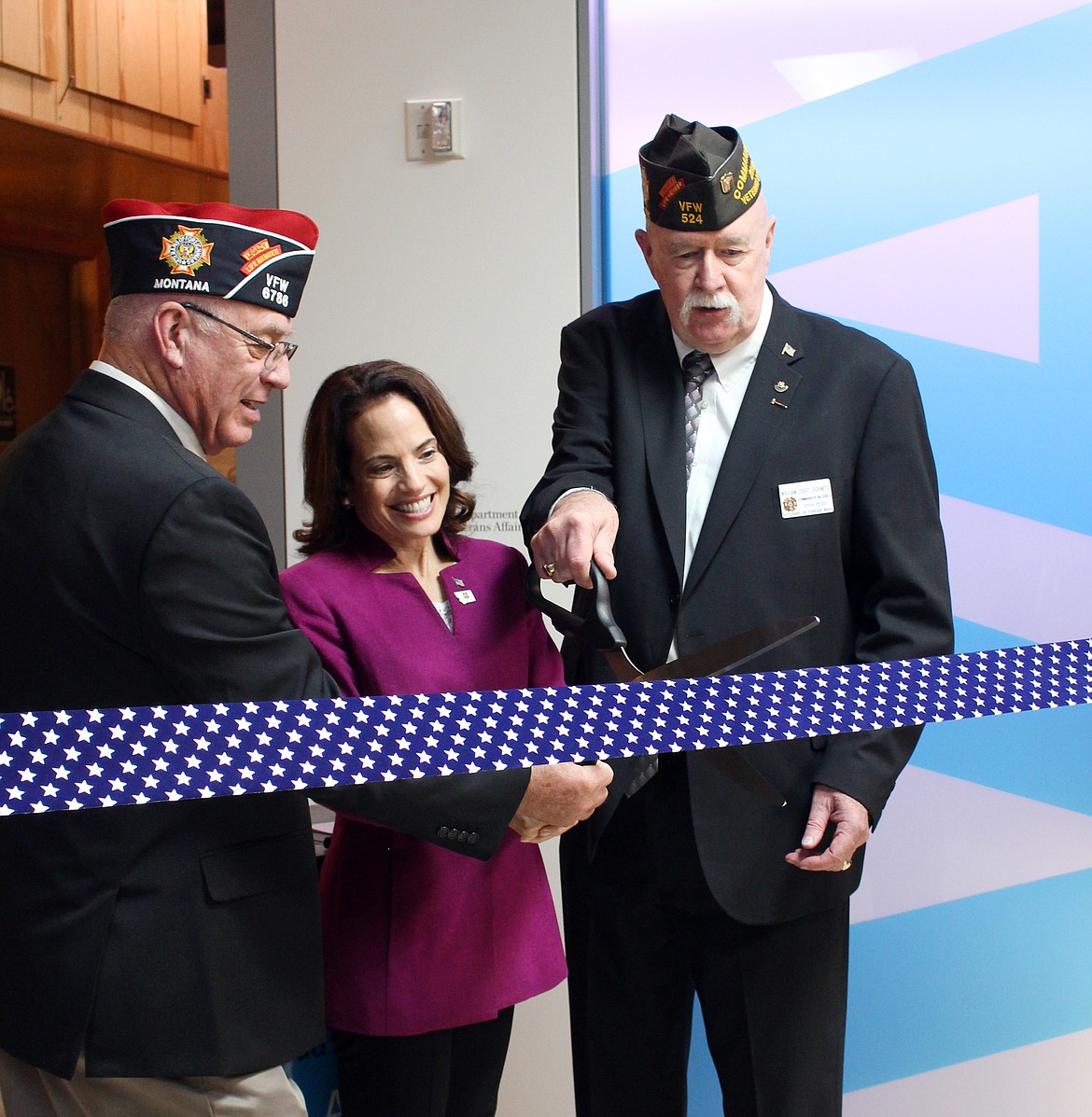VFW Post 6786 Commander Rick Welcon;  Deborah Lafer Scher, executive adviser to the Secretary of the VA; and National VFW Commander-in-Chief William Doc Schmitz (left to right) cut the ribbon for the grand opening of the VA Atlas remote telehealth exam room on Wednesday in Eureka. (Colin Gaiser/Daily Inter Lake)