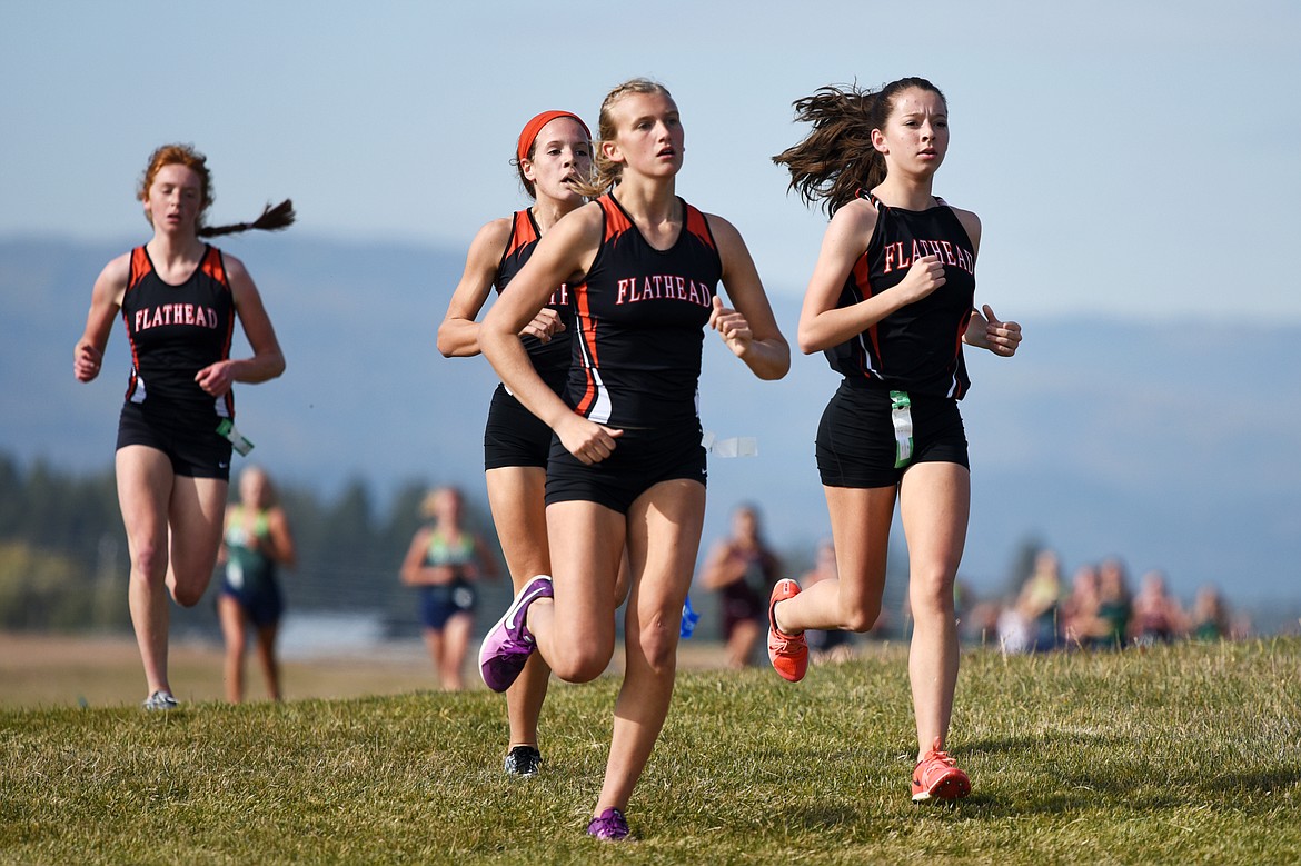 Right to left, Flathead runners Tori Noland-Gillespie, Hannah Perrin, Neila Lyngholm and Madelaine Jellison run the course at the Glacier Invite at Rebecca Farm on Wednesday. (Casey Kreider/Daily Inter Lake)
