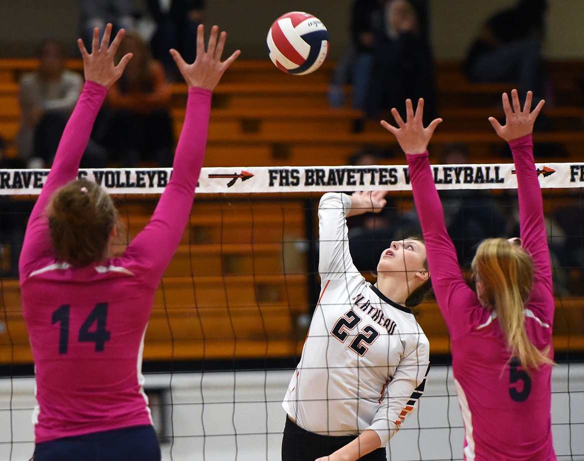 Flathead's Julia Burden (22) looks for a kill against Glacier's Emma Anderson (14) and Kaylee Fritz (5) during crosstown volleyball at Flathead High School on Tuesday. (Casey Kreider/Daily Inter Lake)