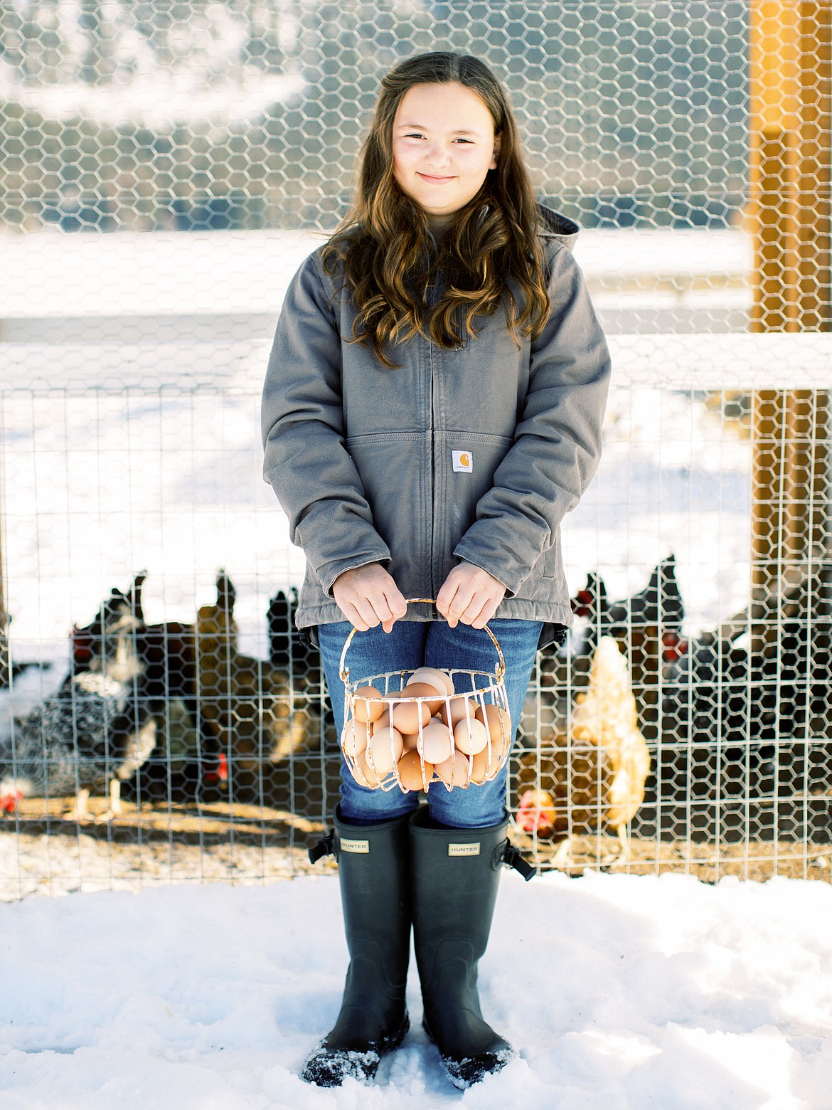 Elaina Dorr, 11, carries a load of fresh eggs from her family&#146;s chickens. (Courtesy of Jeremiah and Rachel Spray Photography)