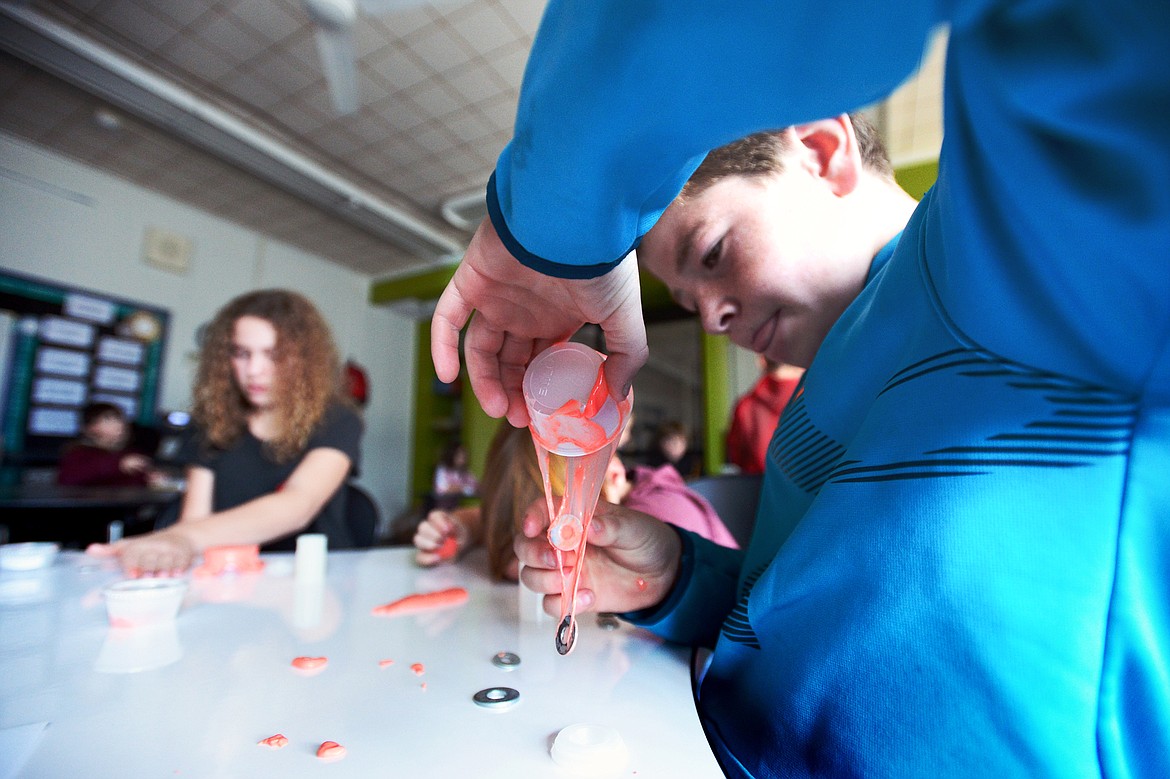 Luke Robinson, a fifth-grader at Elrod Elementary School, tests the strength of his slime during a series of Science on Wheels workshops and exhibits.