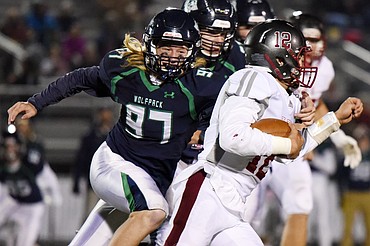 Glacier defensive lineman Thomas Cole (97) chases down Helena quarterback Kaden Huot (12) in the third quarter at Legends Stadium on Friday. (Casey Kreider/Daily Inter Lake)
