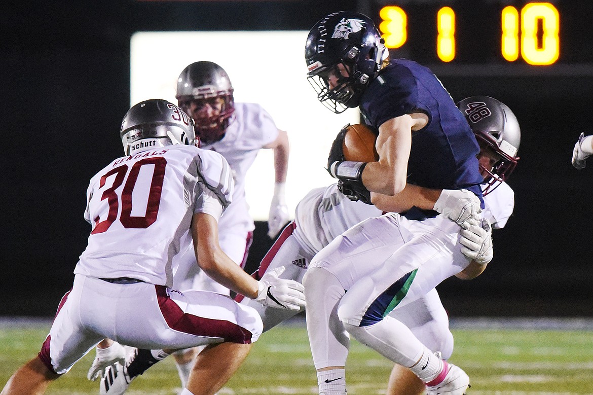 Glacier wide receiver Colin Bowden (1) is brought down by Helena defenders after a third-quarter reception at Legends Stadium on Friday. (Casey Kreider/Daily Inter Lake)