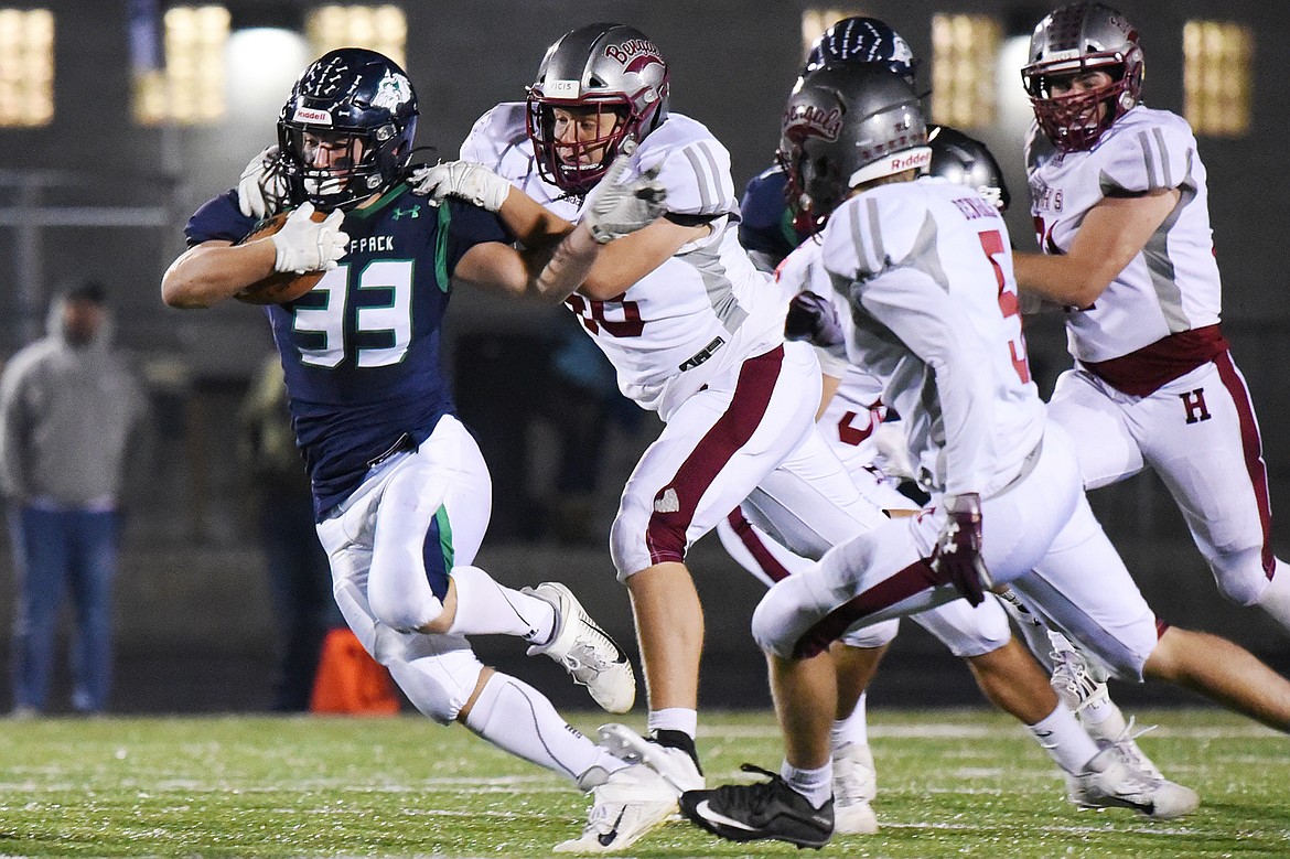 Glacier running back Jake Rendina (33) is brought down by Helena&#146;s Zachary Evans (48) on a third quarter run at Legends Stadium on Friday. (Casey Kreider/Daily Inter Lake)