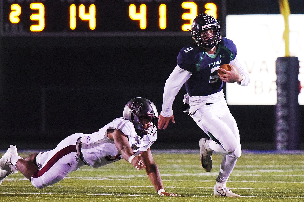 Glacier quarterback JT Allen (3) is chased out of the pocket by Helena&#146;s Forrest Suero (54) in the third quarter at Legends Stadium on Friday. (Casey Kreider/Daily Inter Lake)