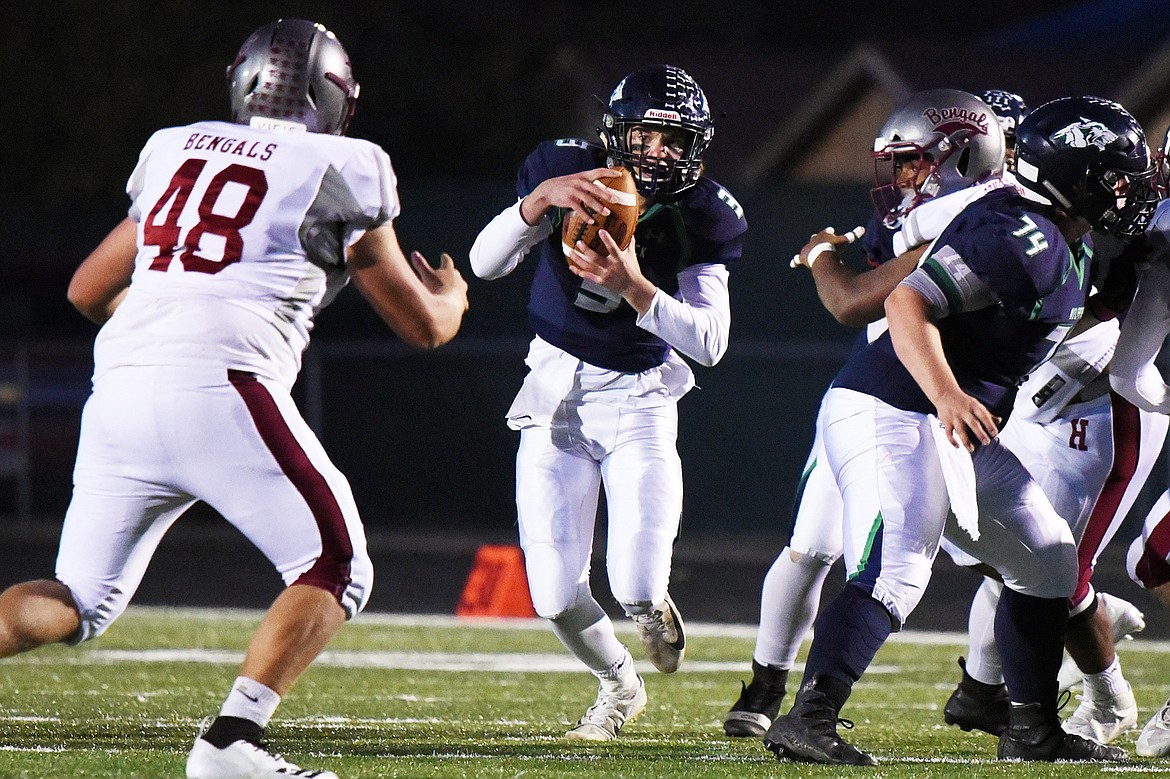 Glacier quarterback JT Allen (3) is chased out of the pocket in the first quarter against Helena at Legends Stadium on Friday. (Casey Kreider/Daily Inter Lake)