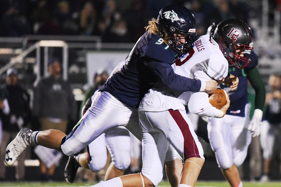 Glacier defensive lineman Thomas Cole (97) chases down Helena quarterback Kaden Huot (12) in the third quarter at Legends Stadium on Friday. (Casey Kreider/Daily Inter Lake)