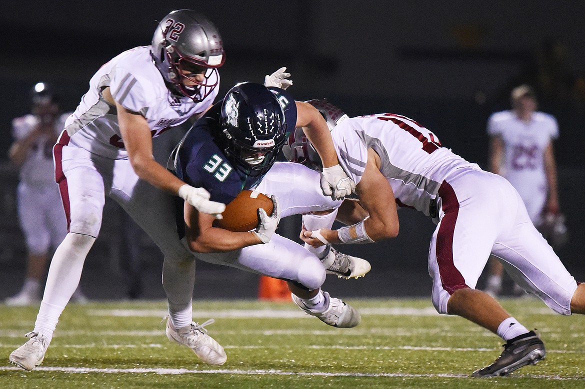 Glacier running back Jake Rendina (33) is brought down on a third quarter run against Helena at Legends Stadium on Friday. (Casey Kreider/Daily Inter Lake)