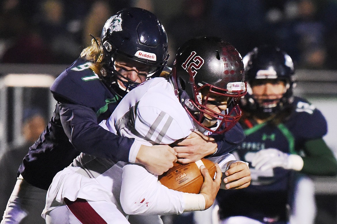 Glacier defensive lineman Thomas Cole (97) chases down Helena quarterback Kaden Huot (12) in the third quarter at Legends Stadium on Friday. (Casey Kreider/Daily Inter Lake)