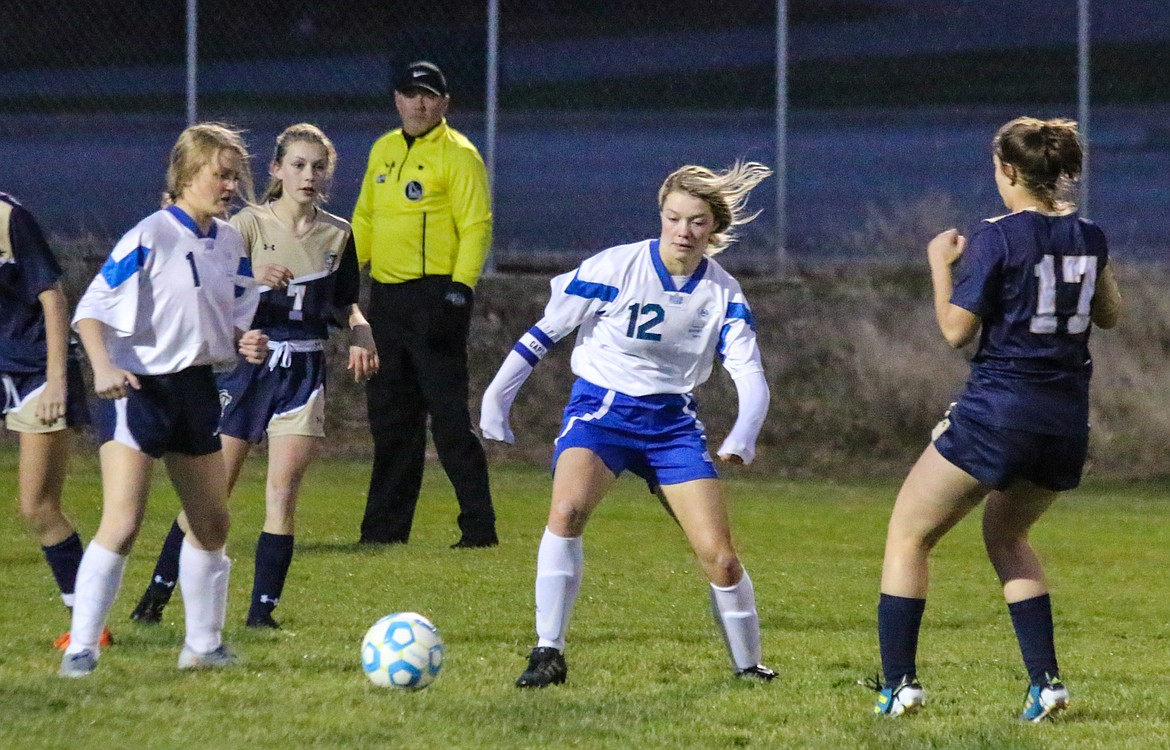 Photos by MANDI BATEMAN
Emma Pinkerton (12) maneuvers between players during the Badgers&#146; 5-0 loss to Timberlake on Oct. 8.