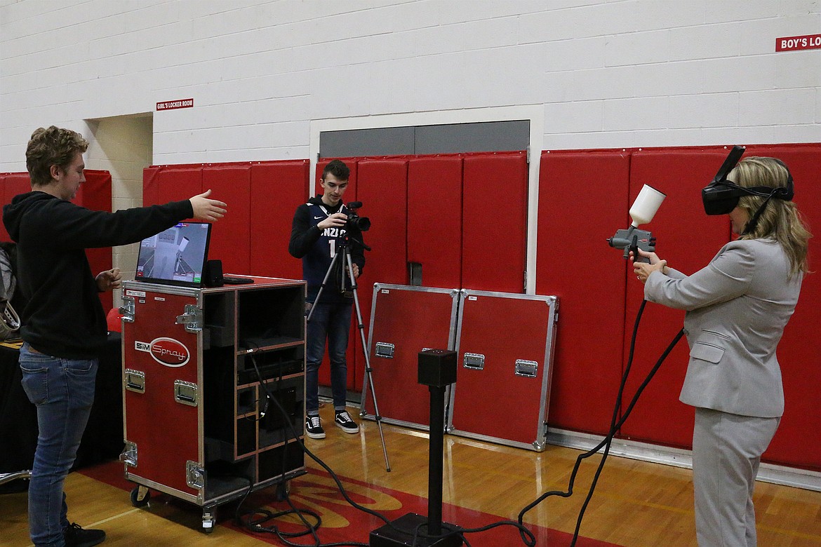 (Photo by MARY MALONE)
Idaho's superintendent of public instruction Sherri Ybarra, right, painted an imaginary car using a virtual reality paint sprayer during the North Idaho College CTE Roadshow at Sandpoint High School on Friday.