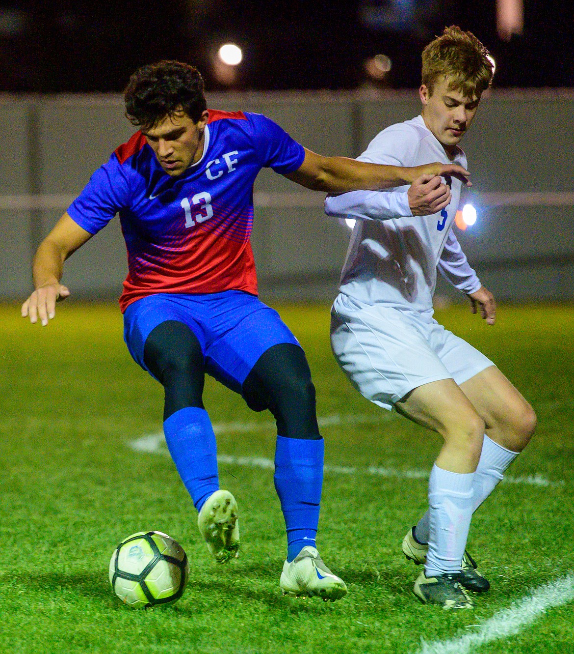 Columbia Falls&#146; Mikey Tamburelli  (right) holds off Libby&#146;s Brett Osborn Thursday night in Columbia Falls. The Wildcats won 9-2. (Chris Peterson/Hungry Horse News)