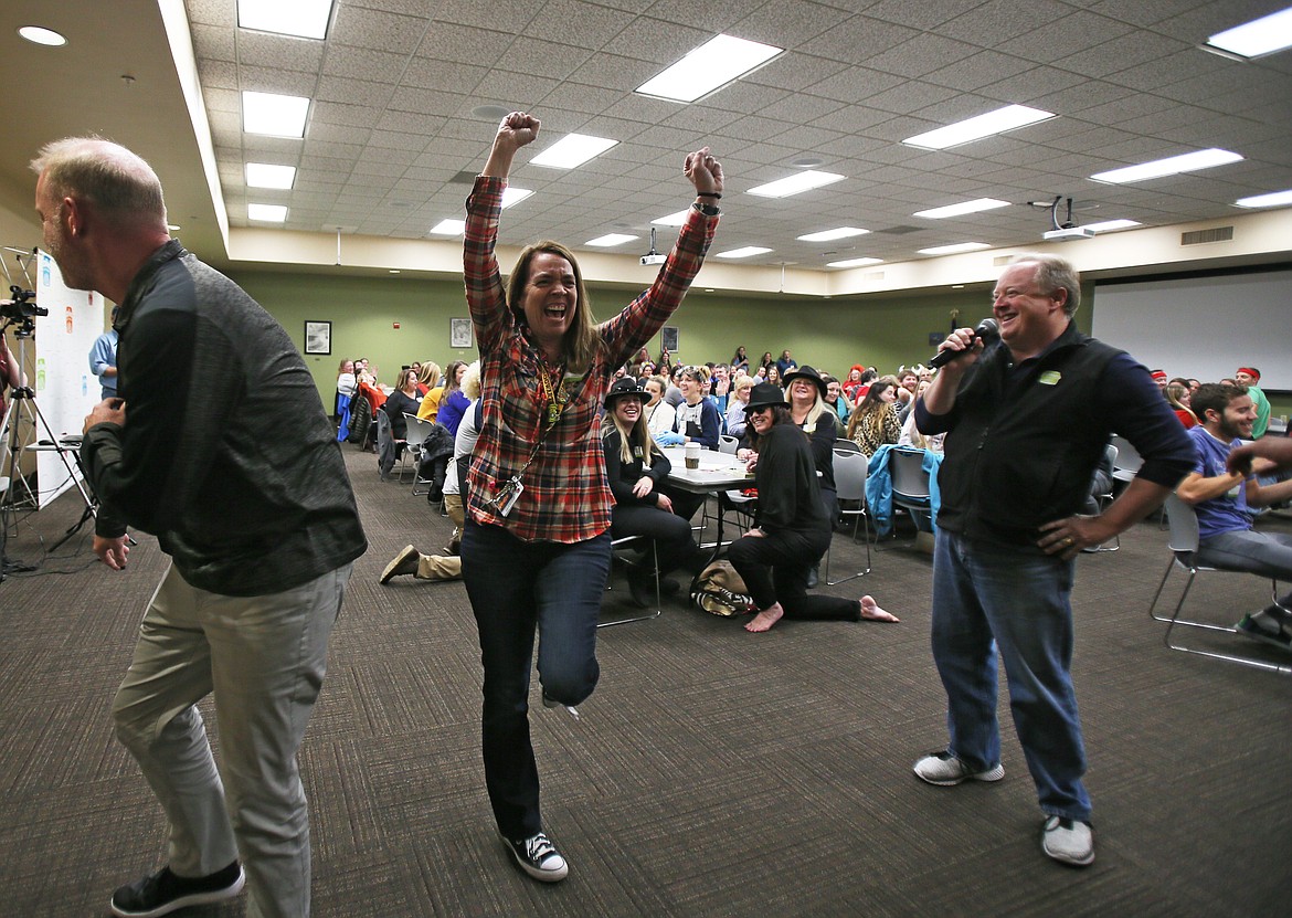 Woodland Middle School sixth-grade teacher Tammy Daddato raises her arms in victory after winning 75 more tickets for her team during the Idaho Lottery's Scratch for Schools fundraising event Wednesday. (DEVIN WEEKS/Press)