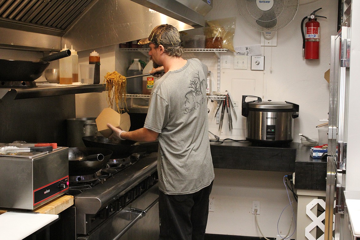 RJ Coates prepares a to-go box of Yakisoba.