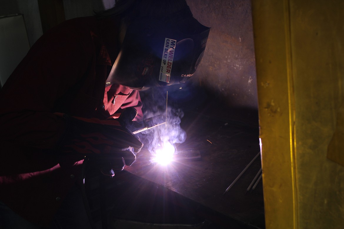 GABBY JARVIS welding on a practice plate, last Thursday. She wants to be a veterinarian, and believes that welding could be a good backup plan, as well as a way to help pay for her school. (John Dowd/Clark Fork Valley Press)