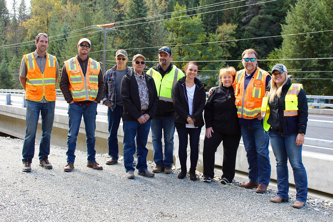 Photo by CHANSE WATSON
From left: James Heilman, C.L Heilman Company, Inc.; Logan Ledgerwood, HMH Engineering; Shane Scuichetti, Shoshone County Road District 3 Supervisor; John Hansen, Shoshone County Commissioner; Jim Cason, Shoshone County Public Works Director; Jessica Stutzke, Shoshone County Public Works; Carol Young, Shoshone County Public Works; Alex Hall, HMH Engineering; and Megan Kautz, LHTAC; smile for the camera in front of the newly completed bridge in Pine Creek on Oct. 8.