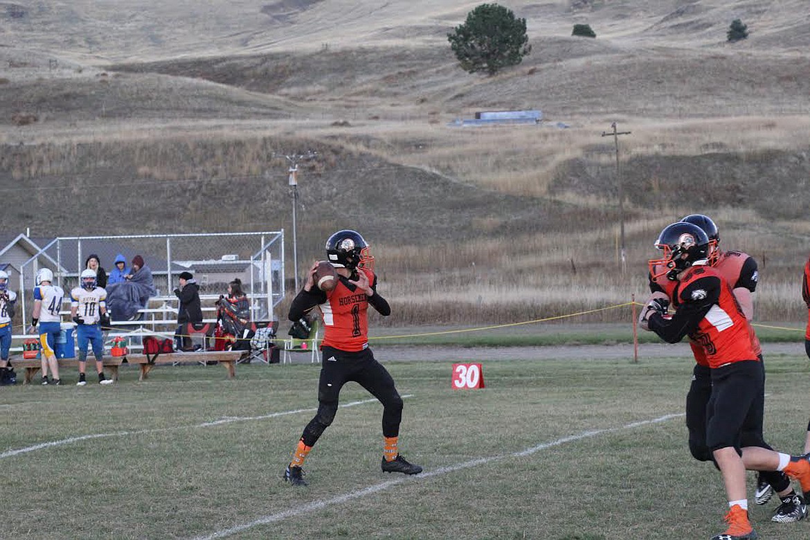 Plains quarterback Treydon Brouillette prepares to throw the ball Friday against Victor. Brouillette&#146;s big game helped the Horsemen to a 66-6 win. (Chuck Bandel/Valley Press)