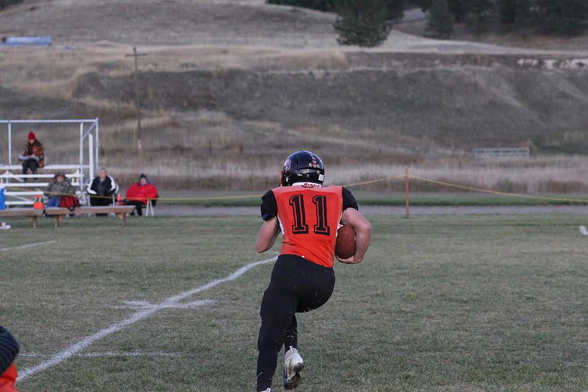 Plains Horseman Nathan McNulty runs with the ball against Victor during Friday's homecoming game. McNulty helped lead the hosts to a 66-6 win. (Chuck Bandel/Valley Press)