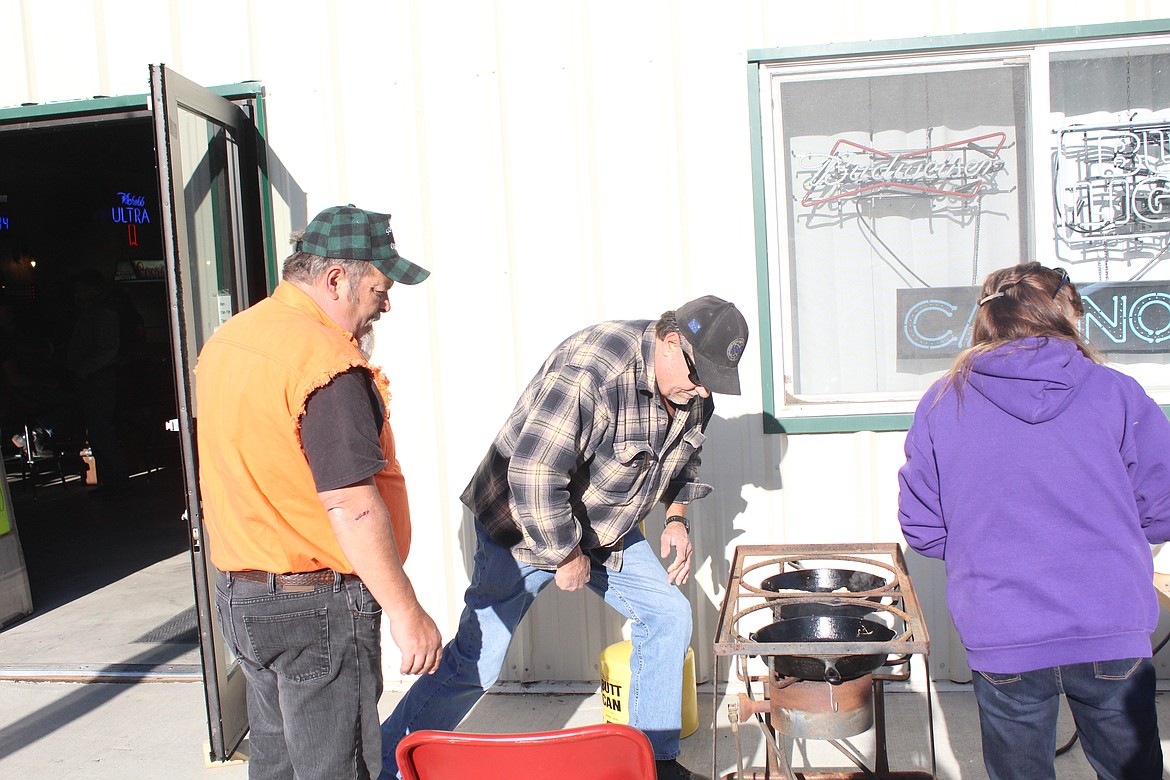 BILL TRULL (plaid) and Buck Larson (orange) setting up the equipment to fry up some fish. (John Dowd/Clark Fork Valley Press)