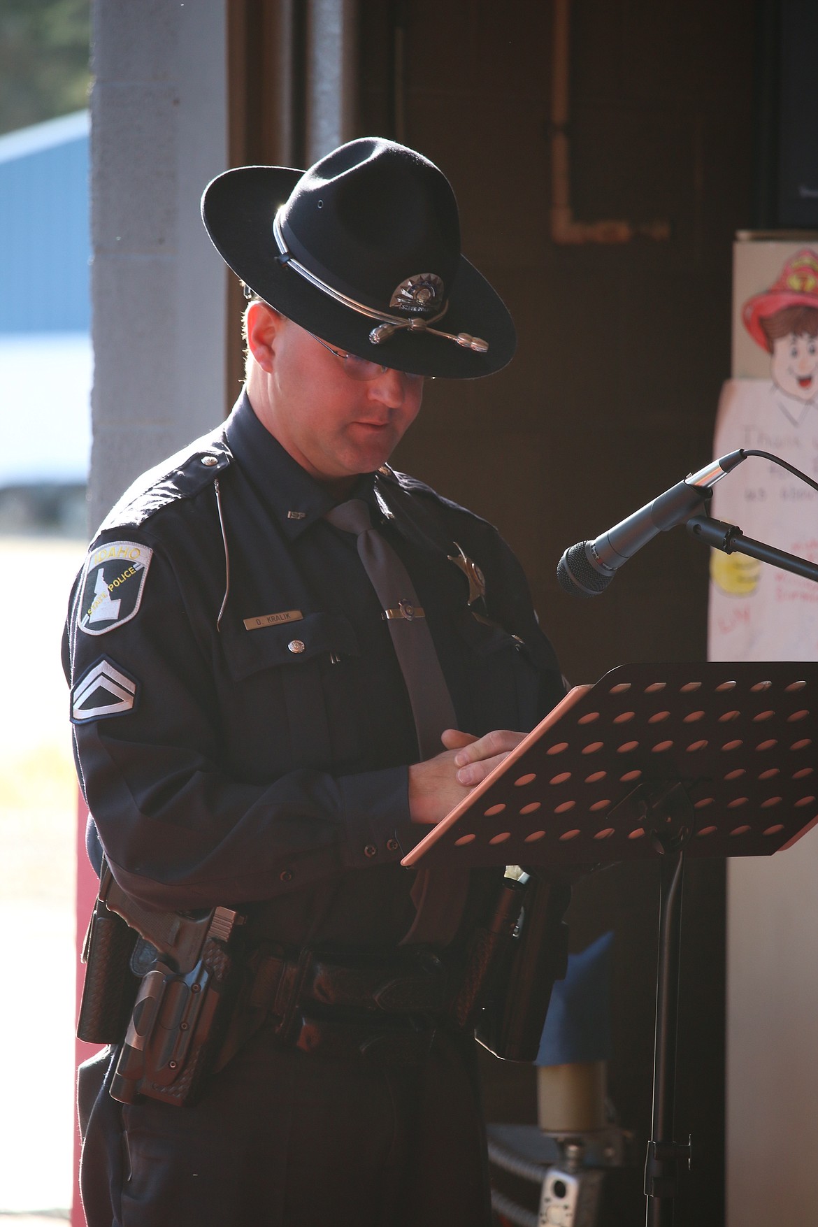 Photo by MANDI BATEMAN
Idaho State Police officer Dustin Kralik reading names of fallen firefighters.