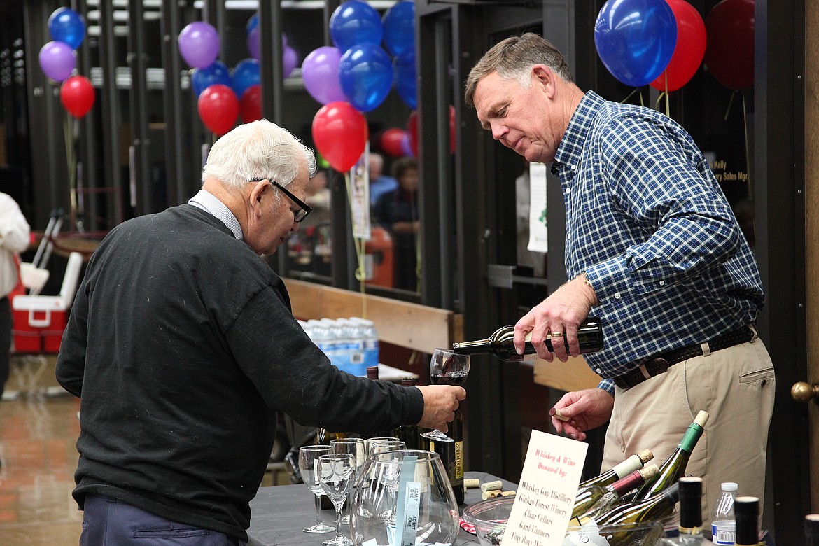 File photo
Former Othello City Administrator Wade Farris pours a glass of wine for a guest at a previous benefit auction for the Old Hotel Art Gallery.