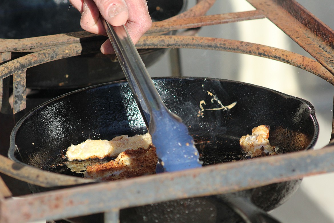 BILL TRULL frying up fish for his Sunday fish fry, two weekends ago. (John Dowd/Clark Fork valley Press)